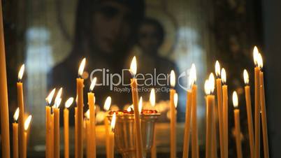 Church candles burn before the icon mother of God
