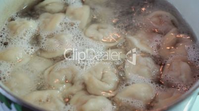 Homemade ravioli is cooked  in the boiling water