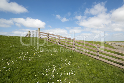 Waddendyke with wooden fence on the island of Terschelling in th