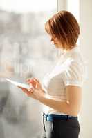 Side view on woman working on tablet