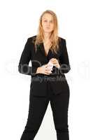 Businesswoman looking at camera while holding smartphone