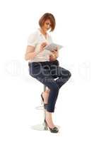 Businesswoman using tablet while sitting on chair