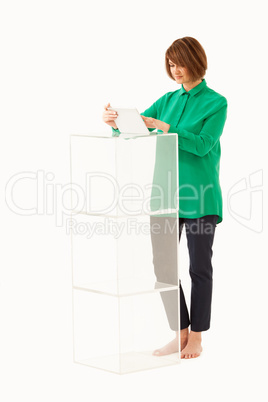 Adult woman using tablet near glass stand