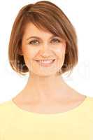 Headshot of beautiful woman in yellow smiling at camera