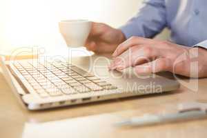 The hand on the keyboard and coffee