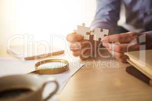 Building a business success. The hands with puzzles