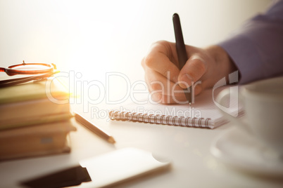 The male hand with a pen and the cup