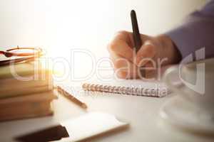 The male hand with a pen and the cup