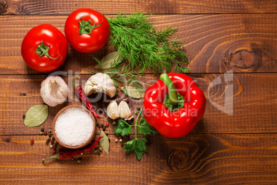 Pepper and tomatoes with garlic on a vintage wooden table
