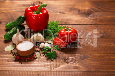 Pepper and tomatoes with garlic on a vintage wooden table