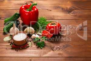 Pepper and tomatoes with garlic on a vintage wooden table