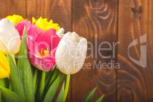 Bouquet Of Tulips In Front Of Spring Scene On The Wooden Background. A bouquet of flowers for March 8, or Valentine's day