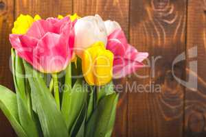 Bouquet Of Tulips In Front Of Spring Scene On The Wooden Background. A bouquet of flowers for March 8, or Valentine's day