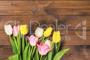 Bouquet Of Tulips In Front Of Spring Scene On The Wooden Background. A bouquet of flowers for March 8, or Valentine's day