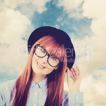 Composite image of smiling hipster woman posing face to the came