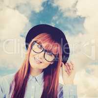 Composite image of smiling hipster woman posing face to the came