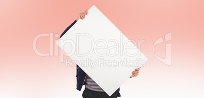 Composite image of man holding billboard in front of face