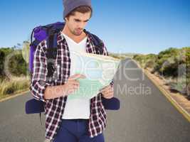 Composite image of man with backpack looking in map