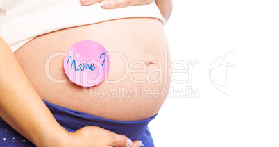 Composite image of pregnant woman with sticker on bump
