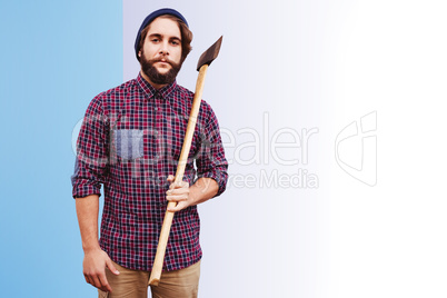 Composite image of portrait of hipster holding axe