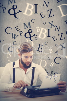 Composite image of hipster using typewriter at desk in office