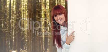 Composite image of smiling hipster woman behind a white card