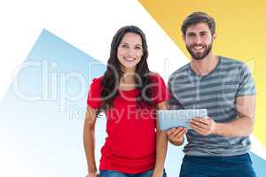 Composite image of couple posing with tablet