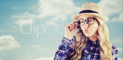 Composite image of gorgeous blonde hipster sending air kiss