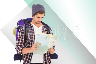 Composite image of man with luggage looking in map