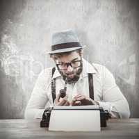 Composite image of hipster smoking pipe while working at desk
