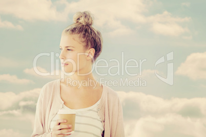 Composite image of woman holding coffee cup