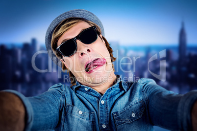 Composite image of crazy hipster wearing sunglasses