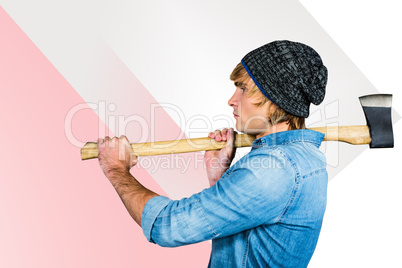 Composite image of side view of hipster standing with axe