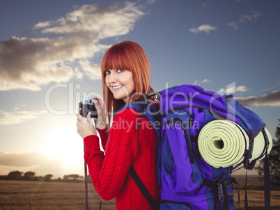 Composite image of smiling hipster woman with a travel bag