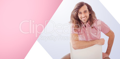 Composite image of portrait of hipster smiling while sitting on