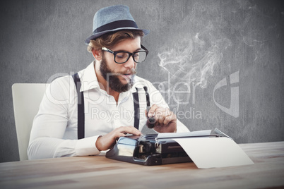 Composite image of hipster holding smoking pipe while working on