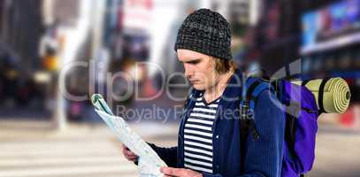 Composite image of backpacker looking a map