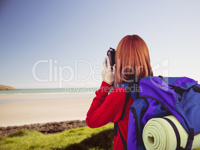 Composite image of smiling hipster woman with a travel bag