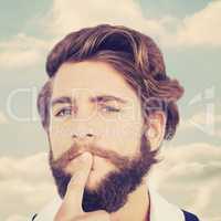 Composite image of portrait of hipster with finger on chin