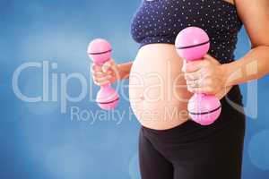Composite image of midsection of pregnant woman lifting dumbbell