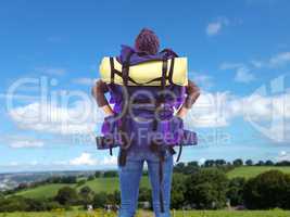 Composite image of rear view of a hipster woman with a travel ba