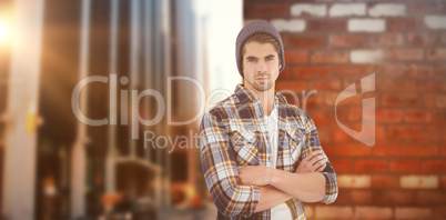 Composite image of portrait of confident hipster with arms cross