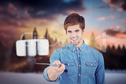 Composite image of hipster taking selfie in office