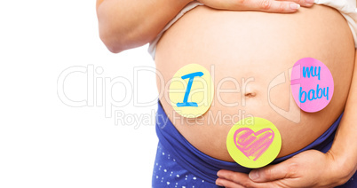 Composite image of pregnant woman with stickers on bump