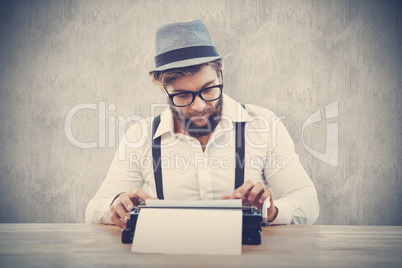 Composite image of hipster wearing eye glasses and hat working o