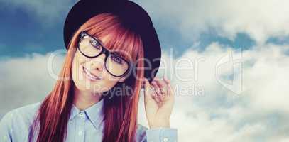 Composite image of smiling hipster woman posing face to the came