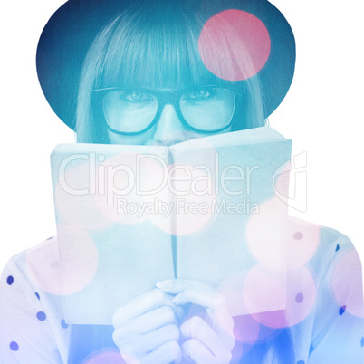 Composite image of hipster woman behind a green book