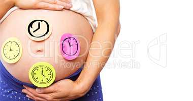 Composite image of pregnant woman with stickers on bump