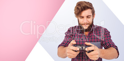 Composite image of hipster playing video game