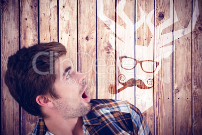 Composite image of shocked hipster looking up